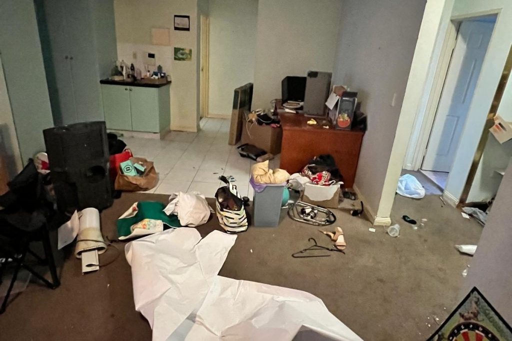Cluttered unit living room before a Rubbish Runners clean-up